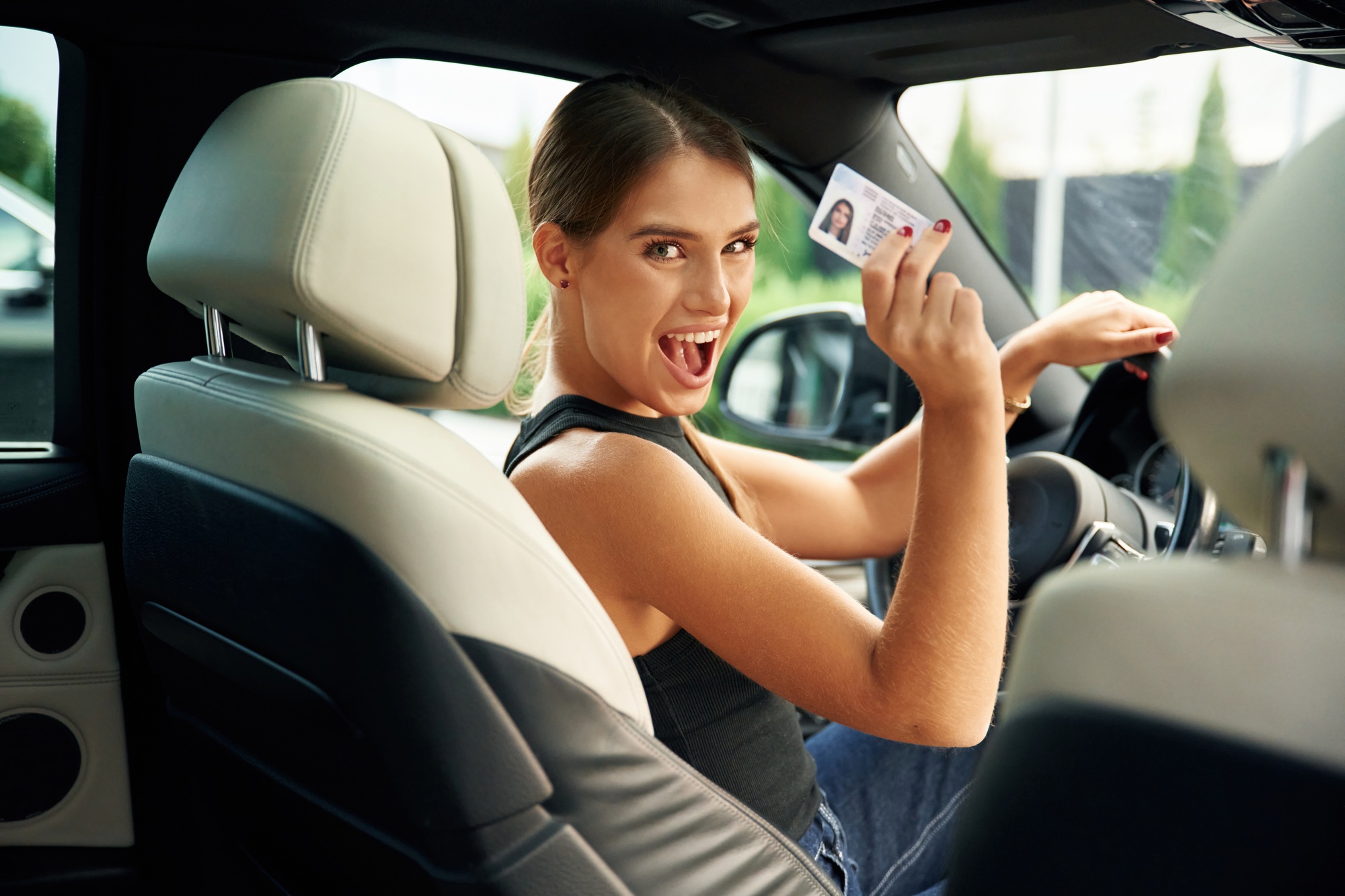 Got driver's license. Woman is sitting in the car